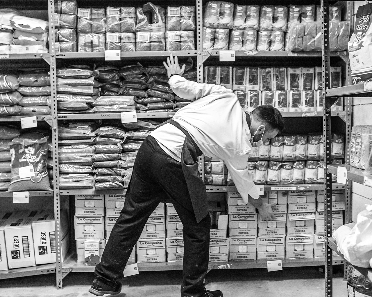A worker organising food in the warehouse of a charitable foundation allied with the Ferrer group.