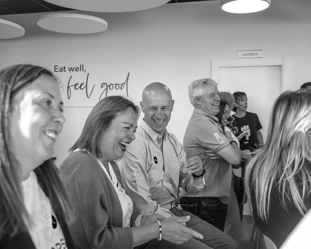 Employees of the Ferrer group smiling and sharing a relaxed moment during a corporate health and wellness activity.