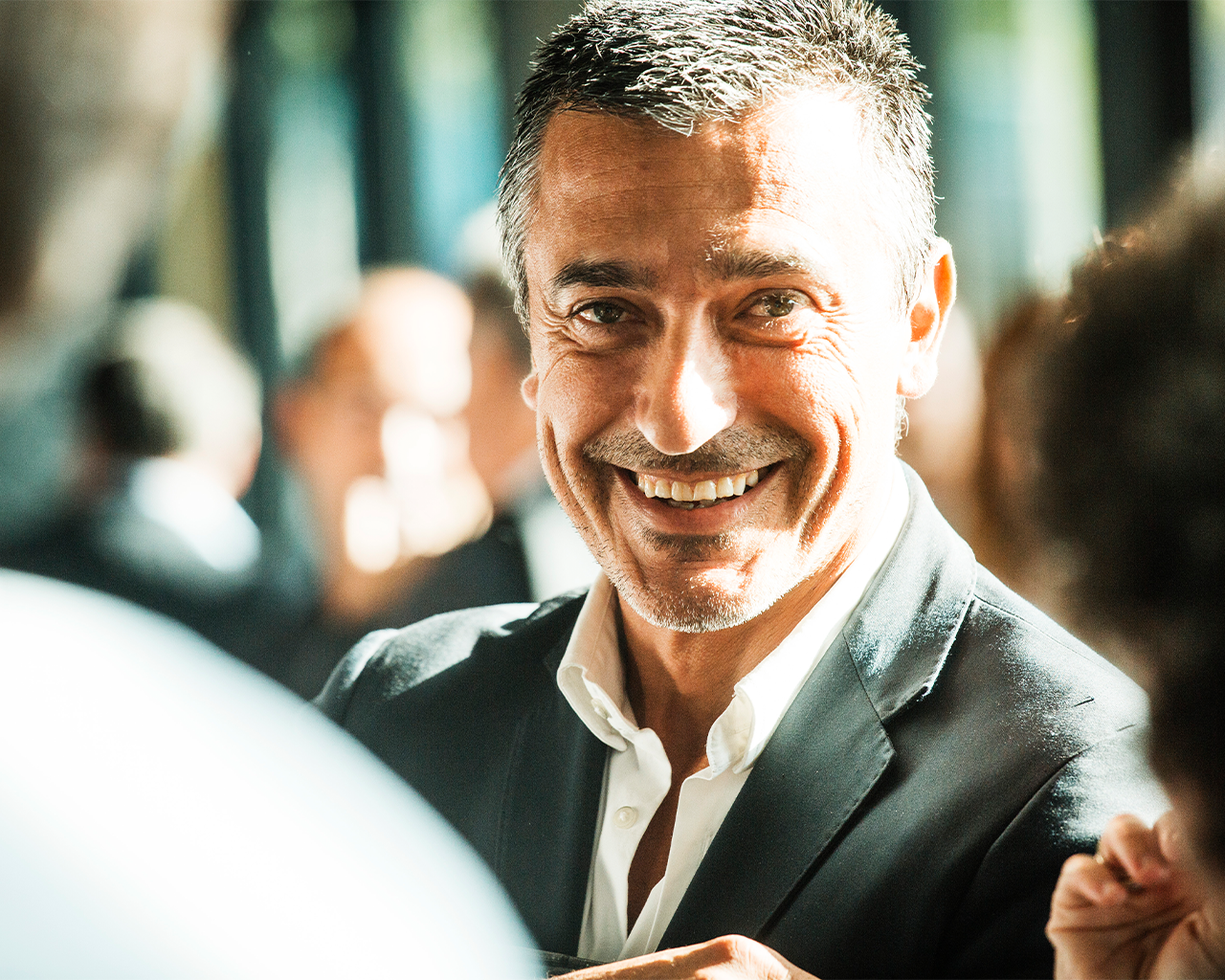 A professional from the Ferrer company smiling during a corporate event.